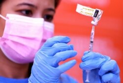 Nurse Darryl Hana prepares a dose of the Pfizer COVID-19 vaccine at a three-day vaccination clinic at Providence Wilmington Wellness and Activity Center on July 29, 2021, in Wilmington, California.