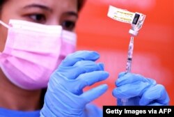 Nurse Darryl Hana prepares a dose of the Pfizer COVID-19 vaccine at a three-day vaccination clinic at Providence Wilmington Wellness and Activity Center on July 29, 2021, in Wilmington, California.