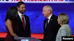 Democratic vice presidential nominee Minnesota Governor Tim Walz and his wife, Gwen, and Republican vice presidential nominee U.S. Senator JD Vance and his wife, Usha, speak at the end of the Vice Presidential debate hosted by CBS in New York, October 1, 2024.