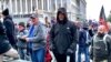 A man (center in black coat) identified by U.S. federal prosecutors as Shane Jason Woods of Auburn, Illinois. is seen in a frame grab from video shot during the Jan. 6, 2021 assault on the U.S. Capitol, moments before attacking members of the news media. 