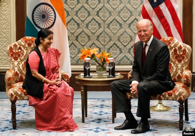 U.S. Vice President Joe Biden (R) and Sushma Swaraj, a leader of India's main opposition Bharatiya Janata Party (BJP), smile as they pose before their meeting in New Delhi July 23, 2013. U.S. business groups on Monday urged Biden to press India's leaders