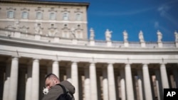 A faithful wait under the closed window of the Apostolic Palace at The Vatican, Feb. 16, 2025, from where Pope Francis, who was hospitalized on Friday, blesses the faithful gathered in St. Peter's Square every Sunday. 