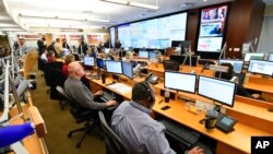 FILE - Personnel at the The Centers for Disease Control and Prevention (CDC) work the Emergency Operations Center in response to the coronavirus, among other threats, Feb. 13, 2020, in Atlanta, Georgia.