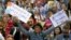 Demonstrators hold placards during a rally in support of refugees that was part of a national campaign in central Sydney, Australia, Oct. 11, 2015.