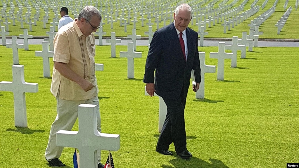 Rex Tillerson, right, U.S. Secretary of State, walks with Bobby Bell, the deputy administrator of the American Battlefield Memorial commission, during Tillerson's visit at the American cemetery in Taguig city, metro Manila, Philippines Aug. 6, 2017. 