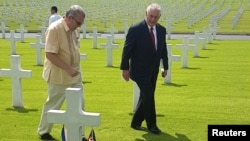 Rex Tillerson, right, U.S. Secretary of State, walks with Bobby Bell, the deputy administrator of the American Battlefield Memorial commission, during Tillerson's visit at the American cemetery in Taguig city, metro Manila, Philippines Aug. 6, 2017. 