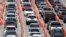Lines of cars wait at a coronavirus testing site outside of Hard Rock Stadium, in Miami Gardens, Fla., June 26, 2020.