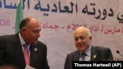 Arab League Secretary-General Nabil Elaraby, right, and Egyptian Foreign Minister Sameh Shukri leave a press conference at the conclusion of an Arab summit meeting in Sharm el-Sheikh, South Sinai, Egypt, Sunday, March 29, 2015. (AP Photo/Thomas Hartwell)