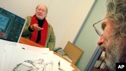 In this Nov. 27, 2001 file photo, cartoonist Gahan Wilson gestures as New Yorker cartoon editor Robert Mankoff looks over Wilson's offerings at the magazine's offices in New York.