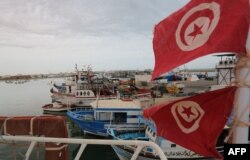 Tunisian fishermen prepare their nets in the port of Zarzis in the southern coast of Tunisia, May 21, 2019. Tunisian fishermen are finding themselves more involved in rescuing illegal boats leaving Libya for Italy.