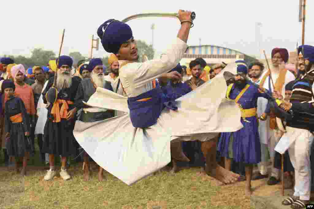 A Nihang, or Sikh warrior, performs an ancient form of Sikh martial arts called Gatka, during a Fateh Divas celebration a day after the Hindu festival Diwali, in Amritsar, India.