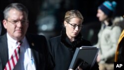 Attorneys for The Boy Scouts of America, Jessica Boelter, center, and Derek Abbott, left, return to their client's bankruptcy hearing in Wilmington, De., Feb. 19, 2020. 