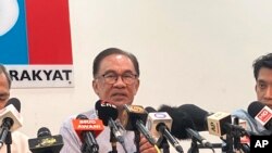 Malaysian opposition leader Anwar Ibrahim speaks during a press conference at his party headquarters in Petaling Jaya, Malaysia, Thursday, Oct. 13, 2022.