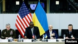 U.S. Chairman of the Joint Chiefs of Staff General Mark Milley, U.S. Secretary of Defense Lloyd Austin, Ukraine's Defense Minister Oleksiy Reznikov, and Ukraine's Major General Eduard Moskaliov attend a meeting at NATO's headquarters in Brussels, Oct. 12, 2022.