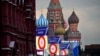 People make preparations for a concert at the Red Square, with constructions reading the words ''Donetsk, Luhansk, Zaporizhzhia, Kherson, Russia'' and St. Basil's Cathedral and Lenin Mausoleum on the background, in Moscow, Sept. 29, 2022.