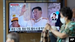 A TV screen showing a news program reporting about North Korea's missile launch with file footage of North Korean leader Kim Jong Un, is seen at the Seoul Railway Station in Seoul, South Korea, Oct. 4, 2022.
