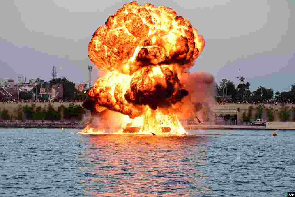 A dummy target is exploded by use of mines by Indian Navy&#39;s divers, as a part of rehearsals for the upcoming defense equipment exhibition - Defence Expo 2022 - at the Sabarmati Riverfront in Ahmedabad.