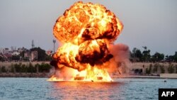 A dummy target is exploded by use of mines by Indian Navy&#39;s divers, as a part of rehearsals for the upcoming defense equipment exhibition - Defence Expo 2022 - at the Sabarmati Riverfront in Ahmedabad.