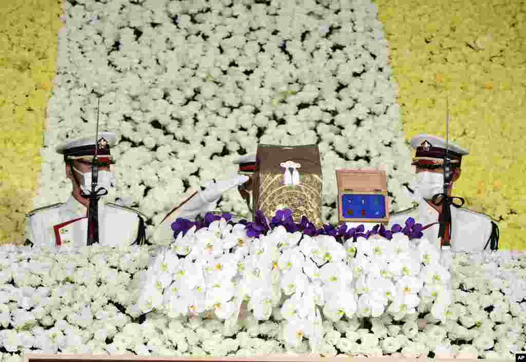 Honor guards salute an urn containing former Prime Minister Shinzo Abe&#39;s ashes during his state funeral in Tokyo, Japan.