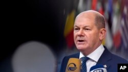 Germany's Chancellor Olaf Scholz speaks with the media as he arrives for an EU summit in Brussels, Thursday, Oct. 20, 2022.