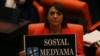 A lawmaker from the main opposition Republican People's Party holds up a placard that reads "Don't touch my social media" in protest at the parliament, in Ankara, Turkey, Oct. 11, 2022.