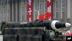 FILE - A missile that analysts believe could be the North Korean Hwasong-12 is paraded in North Korea on April 15, 2017. Japanese Defense Minister Yasukazu Hamada said a missile North Korea fired over Japan on Tuesday could have been a Hwasong-12.