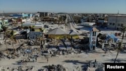 FILE - Remains of destroyed restaurants, shops and other businesses are seen almost one month after Hurricane Ian landfall in Fort Myers Beach, Florida, Oct. 26, 2022. 
