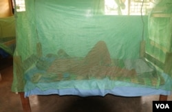A person sleeps under a mosquito net in Balaka district, Malawi, Sept. 28, 2022, as people in the country are encouraged to do to help prevent malaria. (Lameck Masina/VOA)