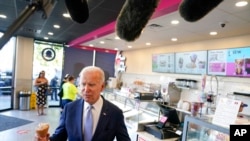 US President Joe Biden speaks to members of the media as he visits a Baskin-Robbins ice cream shop in Portland, Ore., Oct. 15, 2022.