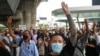 Demonstrators react after Thailand's Constitutional Court delivers its verdict on suspended Prime Minister Prayuth Chan-ocha's tenure, in Bangkok, Thailand, Sept. 30, 2022. 