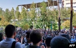 This grab taken from a UGC video made available on the ESN platform on Oct. 10, 2022 shows Iranian students chanting slogans as they protest at Tehran's Amirkabir University of Technology. (Anonymous / ESN via AFP)