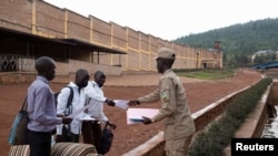 Rwandan reporters with the YouTube channel Iwacu TV, Jean Baptiste Nshimiyimana, Niyonsenga Schadrack, and Jean Damascene Mutuyimana are cleared outside the Mageragere Prison near Kigali, Rwanda October 5, 2022.