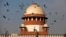 FILE- Pigeons fly past the dome of India's Supreme Court building in New Delhi, India, Feb. 2, 2016. India's Supreme Court ruled Sept. 29, 2022, that all women, regardless of marital status, can obtain abortions up to 24 weeks into their pregnancies. 