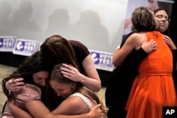 People hug after a referendum to remove abortion protections from the constitution of the state of Kansas failed, Aug. 2, 2022, in Overland Park, Kansas.