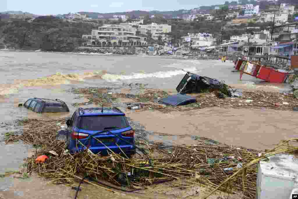 Cars submerged in water, following heavy thunderstorms, in the village of Agia Pelagia, on the island of Crete, Greece, Oct. 15, 2022. 