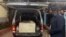 A wooden coffin containing the body of Pakistani journalist Arshad Sharif is loaded into a van at the Chiromo mortuary in Nairobi, Kenya, Oct. 24, 2022. 
