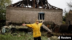 A woman reacts as she talks to journalists following a Russian missile strike, as Russia's attack on Ukraine continues, in Kramatorsk, Donetsk region, Ukraine, Oct. 4, 2022. 