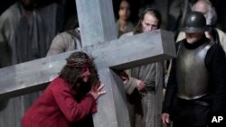 FILE - Rochus Rueckel as Jesus performs with cast members during the rehearsal of the 42nd Passion Play in Oberammergau, Germany, May 4, 2022