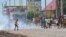 FILE: Protestors throw rocks and block roads after the outlawed opposition group, The National Front for the Defense of the Constitution (FNDC), called for protests against the ruling Junta in Conakry on October 20,2022. On May 23, 2023, private media staged a one-day halt.