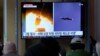  A TV shows images of a North Korean missile launch during a news program at the Seoul Railway Station in Seoul, South Korea, Oct. 13, 2022. 