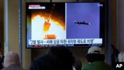  A TV screen shows file images of a North Korean missile launch during a news program at the Seoul Railway Station in Seoul, South Korea, Oct. 13, 2022. 