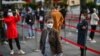 People wait in line to get tested for the coronavirus, in Jing'an district, Shanghai, China, Oct. 25, 2022.