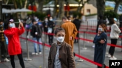People wait in line to get tested for the coronavirus, in Jing'an district, Shanghai, China, Oct. 25, 2022.
