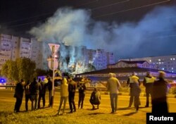 A view shows a site of a plane crash on residential building in the southern city of Yeysk, Russia, Oct. 17, 2022.