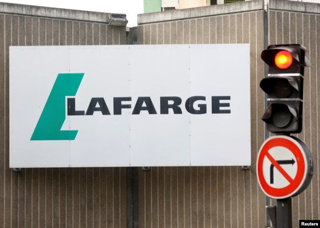FILE - The logo of French concrete maker Lafarge is seen on the plant of Bercy on the banks of the river Seine in Paris, France, Sept. 3, 2020.