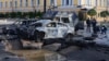 Damaged cars are seen at the scene of Russian shelling, in Kyiv, Ukraine, Oct. 10, 2022. Explosions on Monday rocked multiple cities across Ukraine, including missile strikes on the capital Kyiv for the first time in months.