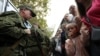 Relatives say good-bye to conscripts as they depart for military bases, in Sevastopol, Crimea. September 27, 2022. (REUTERS/Alexey Pavlishak)