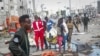 Rescuers remove a body from the scene of a double car bomb attack in Mogadishu, Somalia, Oct. 29, 2022.