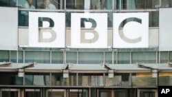 FILE - The BBC sign outside the headquarters of the organization, in London, July 19, 2017. 