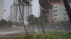 A man walks along the beach following the passage of typhoon Noru in Danang on September 28, 2022. 